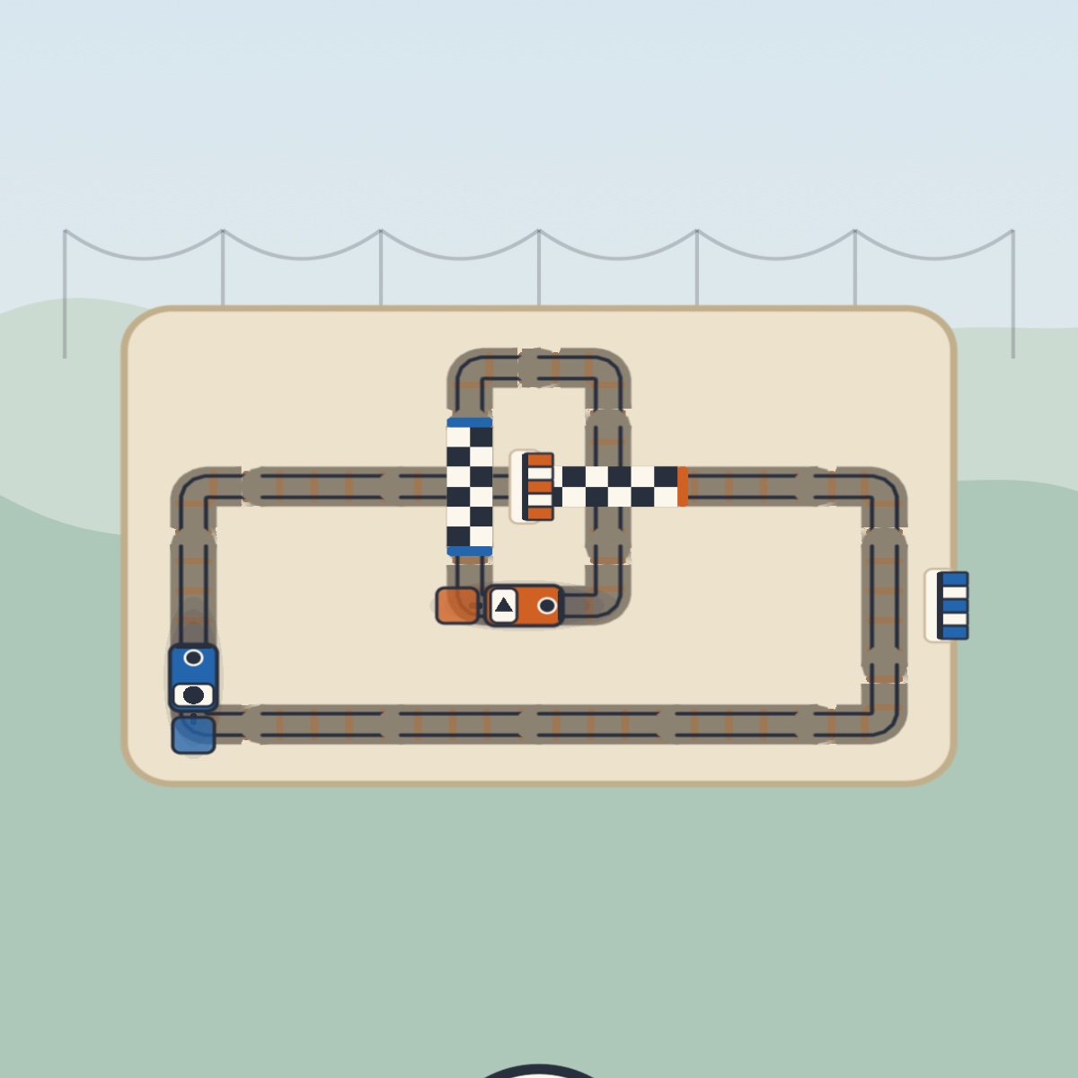 The Lokki yard: two loops of track, a blue locomotive and a checkered start line